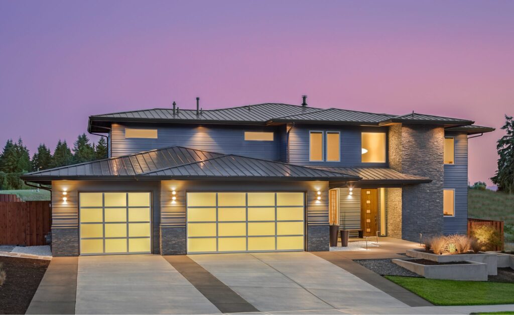 Image of a two storey home at dusk with a concrete driveway